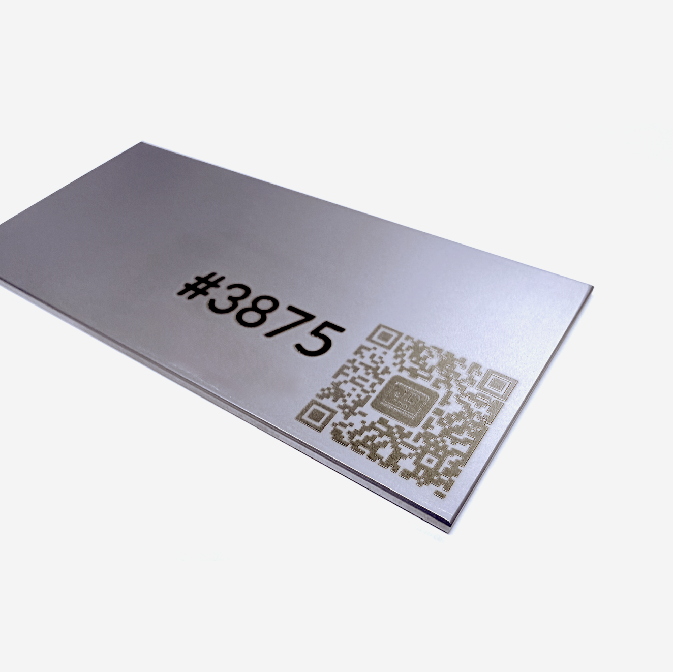 A metal part that has laser marked with a part number and QR Code.